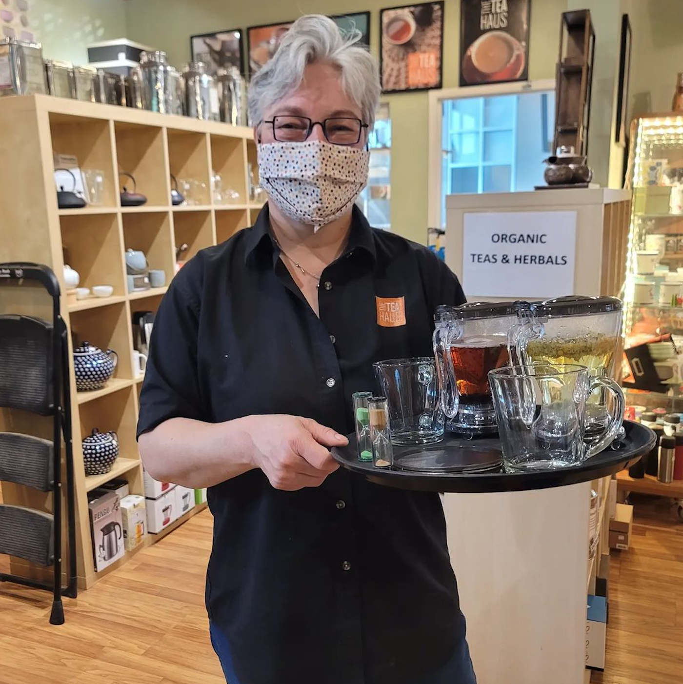 tea haus owner serving tea samples